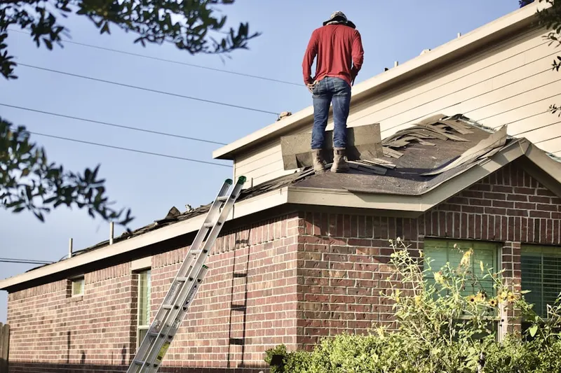 Professional roofer working on a residential roof in Lovely